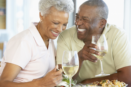 Older couple enjoy a meal together with no issues eating because of partial dentures from Dentures Alaska in Anchorage, AK.